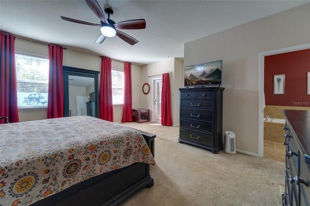 bedroom featuring connected bathroom, light carpet, and ceiling fan