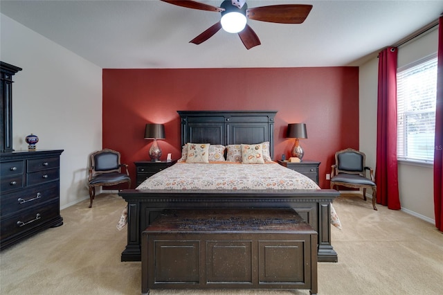 carpeted bedroom with ceiling fan and multiple windows