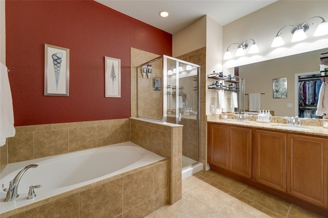 bathroom with tile patterned floors, independent shower and bath, and vanity