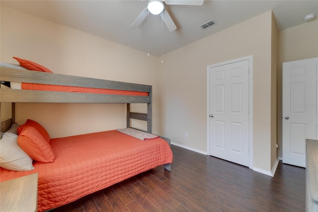 bedroom with dark hardwood / wood-style floors and ceiling fan