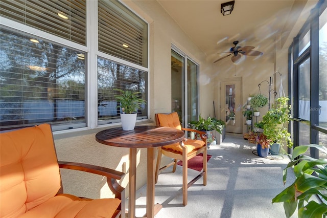 sunroom / solarium featuring a wealth of natural light and ceiling fan