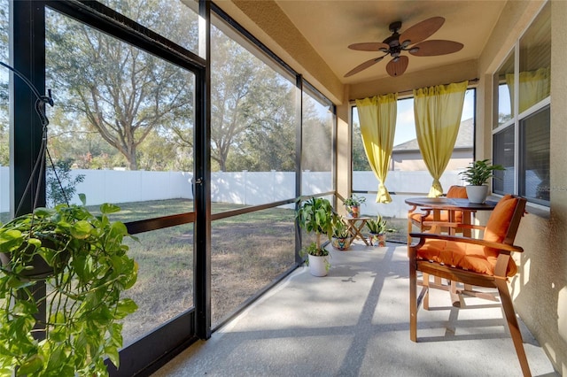 sunroom featuring ceiling fan