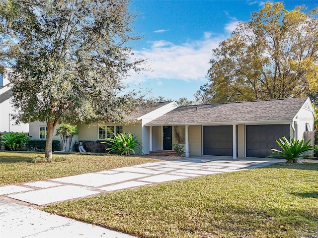 view of front of home with a garage and a front lawn