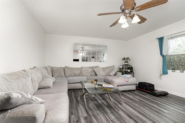 living room with ceiling fan, hardwood / wood-style floors, and a textured ceiling