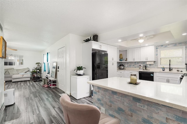 kitchen featuring black appliances, sink, white cabinets, light hardwood / wood-style floors, and ceiling fan