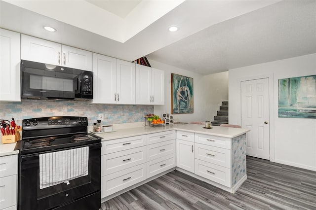 kitchen featuring white cabinetry, dark hardwood / wood-style floors, black appliances, decorative backsplash, and kitchen peninsula