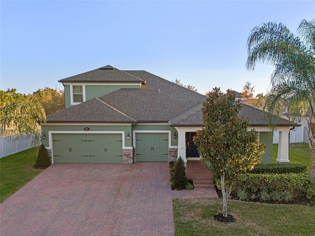 view of front of house with a garage and a front yard