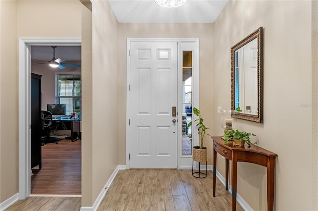 foyer with ceiling fan and light hardwood / wood-style flooring