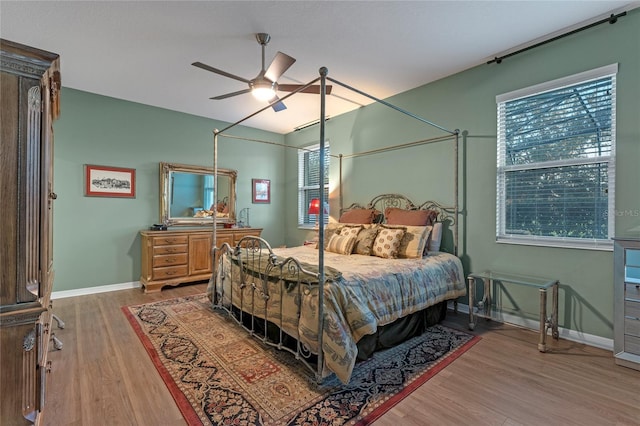 bedroom with ceiling fan and wood-type flooring