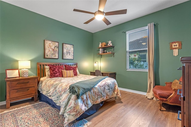 bedroom with light hardwood / wood-style floors and ceiling fan