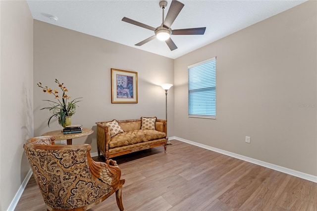 living area featuring ceiling fan and light hardwood / wood-style flooring