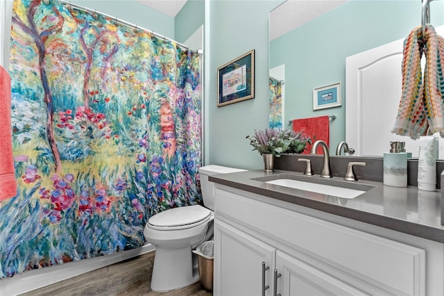 bathroom with vanity, hardwood / wood-style flooring, and toilet