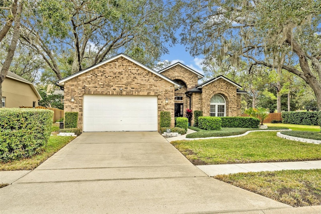 view of front of house with a garage and a front lawn