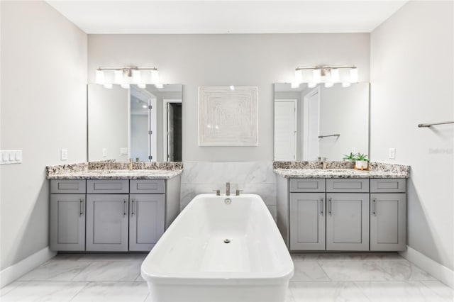 bathroom featuring a washtub and vanity