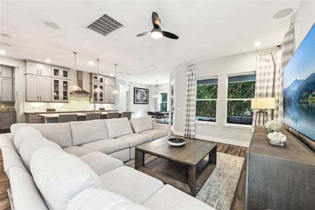 living room with dark hardwood / wood-style floors and ceiling fan