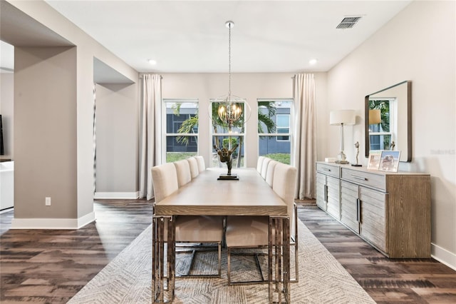 dining area with an inviting chandelier and dark wood-type flooring