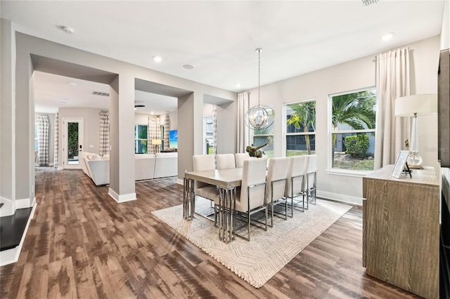 dining area with hardwood / wood-style flooring and a chandelier