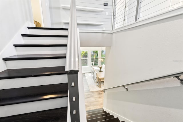 stairs featuring hardwood / wood-style floors