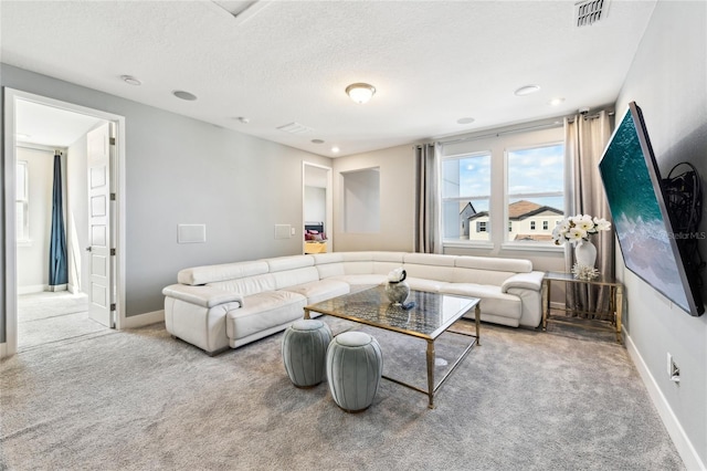 living room featuring carpet floors and a textured ceiling