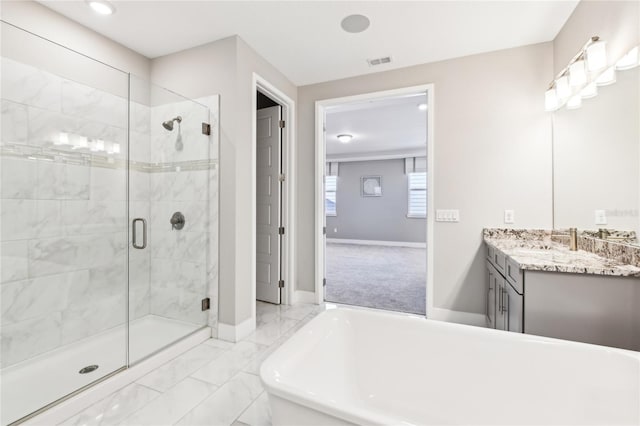 bathroom with vanity and separate shower and tub