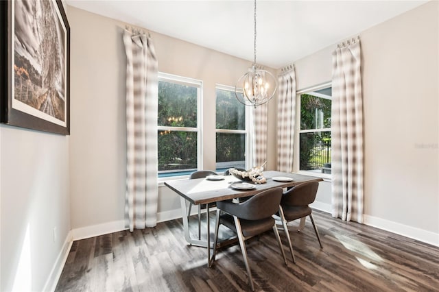 dining space featuring dark hardwood / wood-style flooring and a notable chandelier