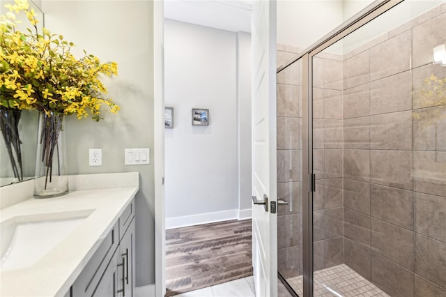 bathroom featuring vanity, hardwood / wood-style floors, and walk in shower