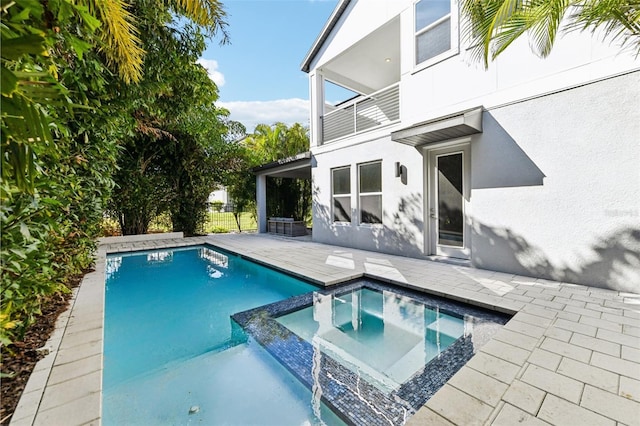 view of swimming pool with a patio area and an in ground hot tub