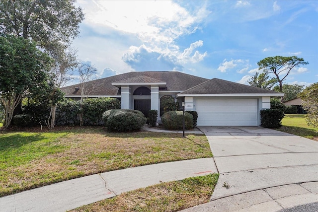 single story home featuring a garage and a front yard