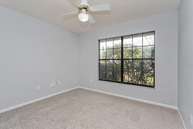 spare room with ceiling fan, carpet, and a textured ceiling