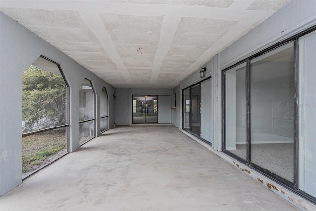 unfurnished sunroom featuring a healthy amount of sunlight