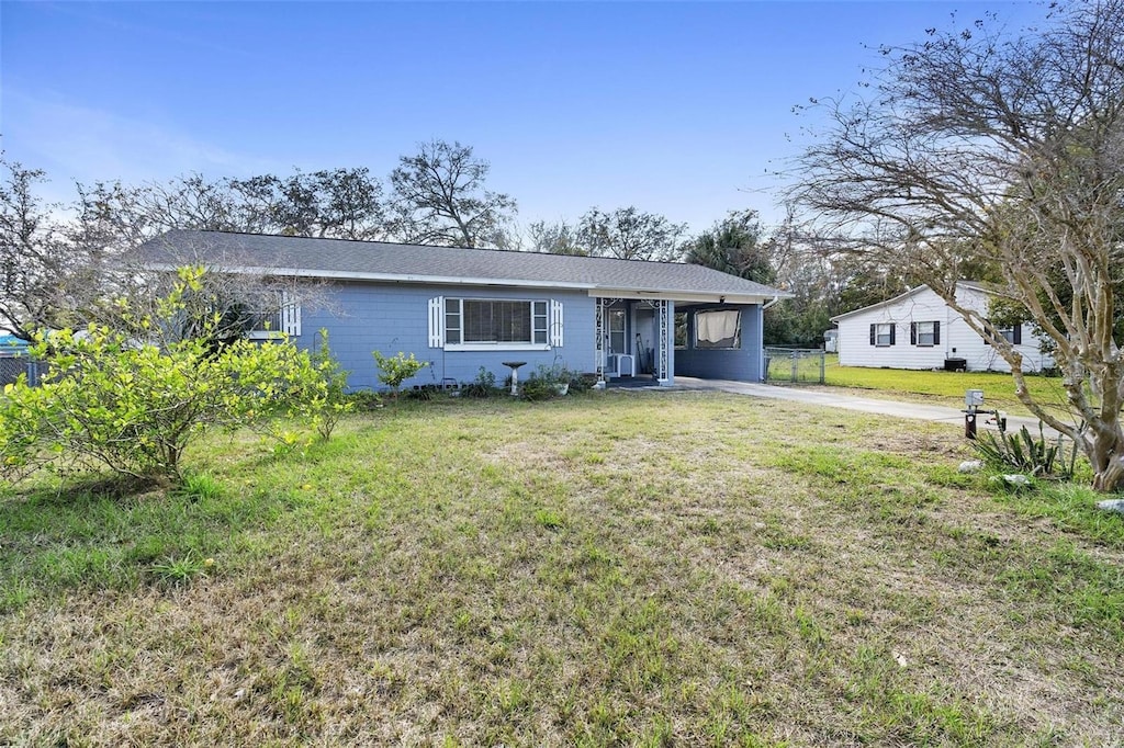 ranch-style house featuring a front yard and a carport