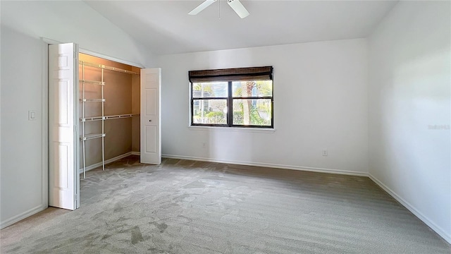 unfurnished bedroom featuring baseboards, lofted ceiling, ceiling fan, carpet floors, and a closet