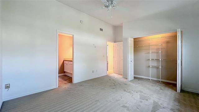 unfurnished bedroom featuring carpet, a closet, visible vents, ensuite bath, and baseboards