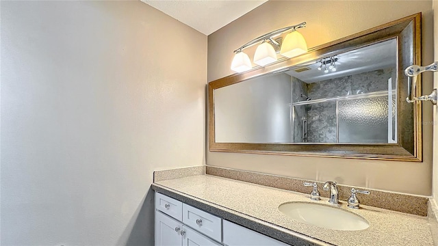 bathroom with an enclosed shower and vanity