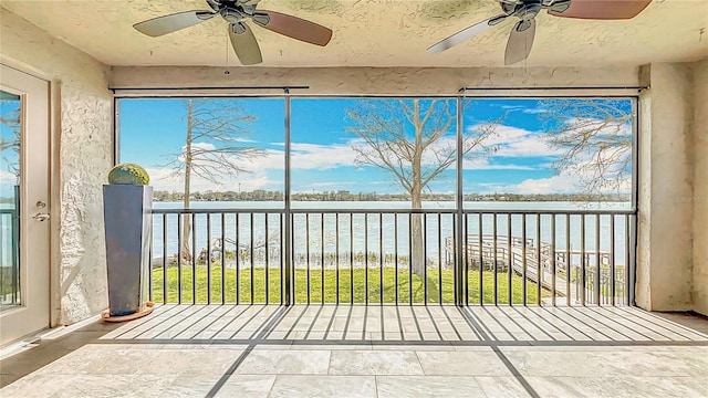 unfurnished sunroom with a water view