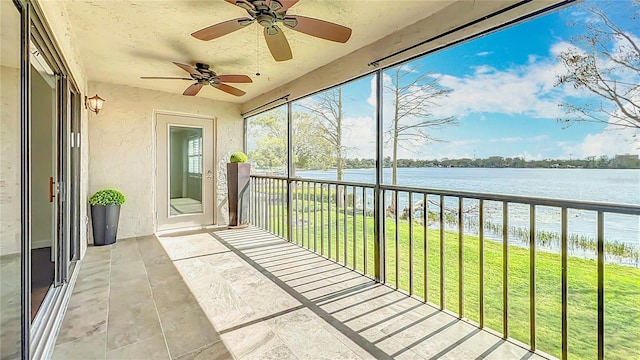 unfurnished sunroom featuring a water view