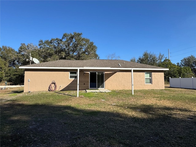 back of house with a yard