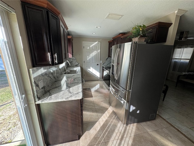 kitchen featuring light stone counters, stainless steel fridge with ice dispenser, sink, and light tile patterned flooring