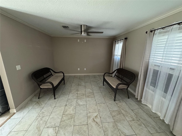 living area featuring a textured ceiling, ornamental molding, and ceiling fan