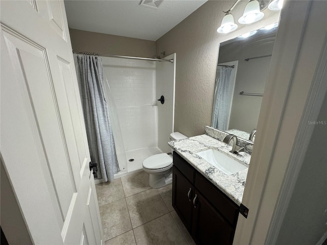 bathroom featuring tile patterned flooring, vanity, a shower with shower curtain, and toilet