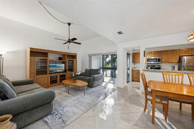 living room with lofted ceiling, sink, a textured ceiling, light tile patterned floors, and ceiling fan