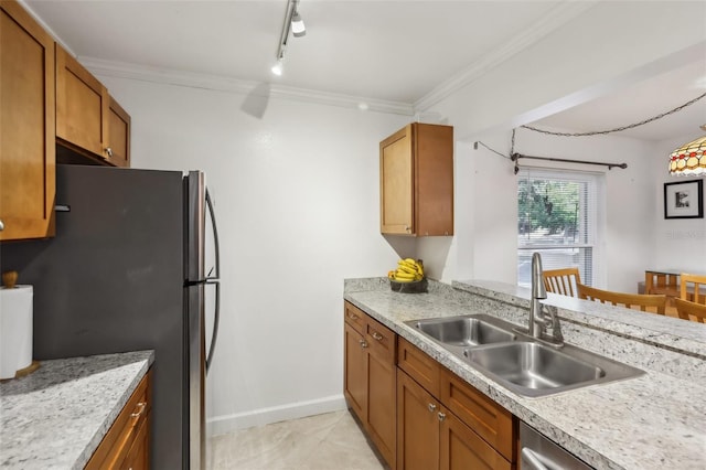 kitchen with light tile patterned flooring, rail lighting, sink, ornamental molding, and stainless steel appliances