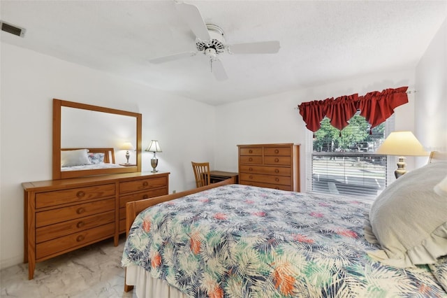 bedroom featuring a textured ceiling and ceiling fan