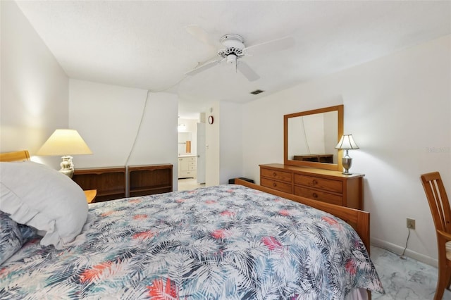 bedroom featuring ensuite bath and ceiling fan