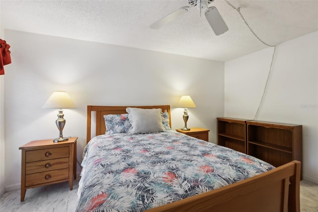 bedroom featuring ceiling fan and a textured ceiling