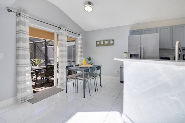 dining space featuring lofted ceiling