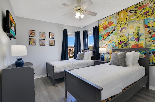 bedroom featuring ceiling fan, wood-type flooring, and a textured ceiling