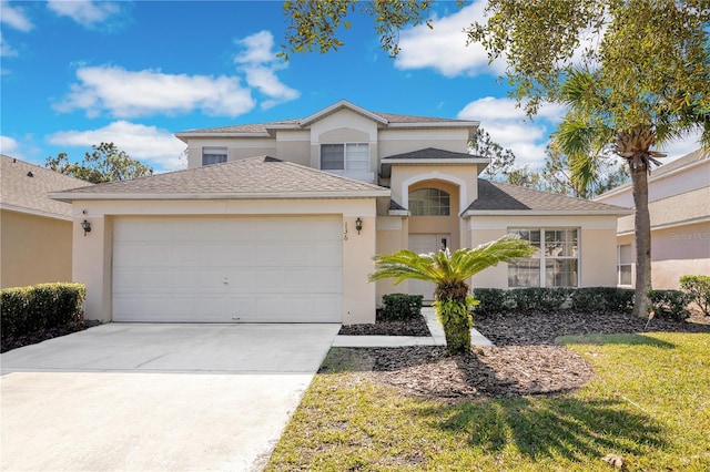 view of front of home featuring a garage and a front lawn