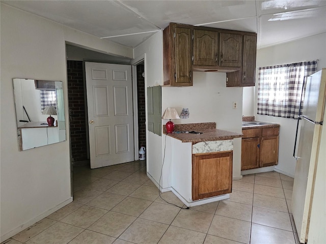 kitchen with white fridge and light tile patterned floors