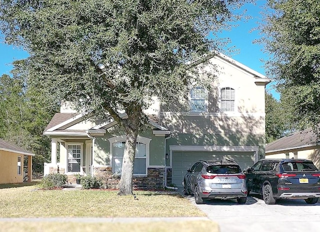 view of front of house featuring a garage and a front lawn